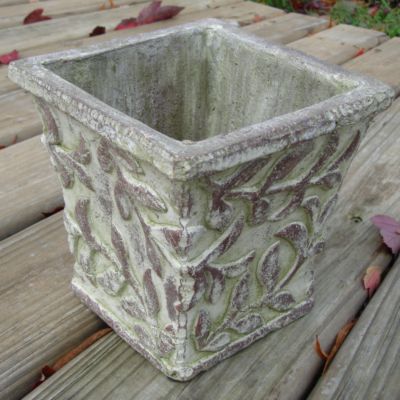 Antiqued Leaf Cachepot: A ceramic cachepot with a raised leaf embellishment and antique white finish with moss green highlights; 6 inches tall and wide with a depth of 5 inches.